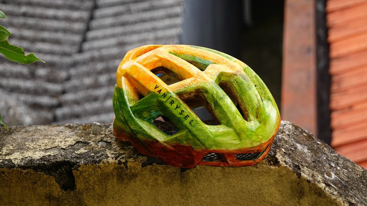 A bicycle helmet resting on a stone wall