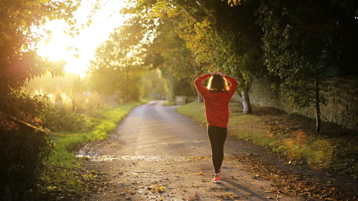 A person walking briskly on a pathway for fitness