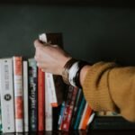 How to Improve Focus and Memory in Bangladesh: A Science-Backed Guide Person selecting a book from a shelf — improving focus and memory