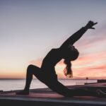 Flexibility and Mobility at Home in Bangladesh: A 10-Minute Daily Routine Person stretching in a yoga pose at sunset — flexibility and mobility